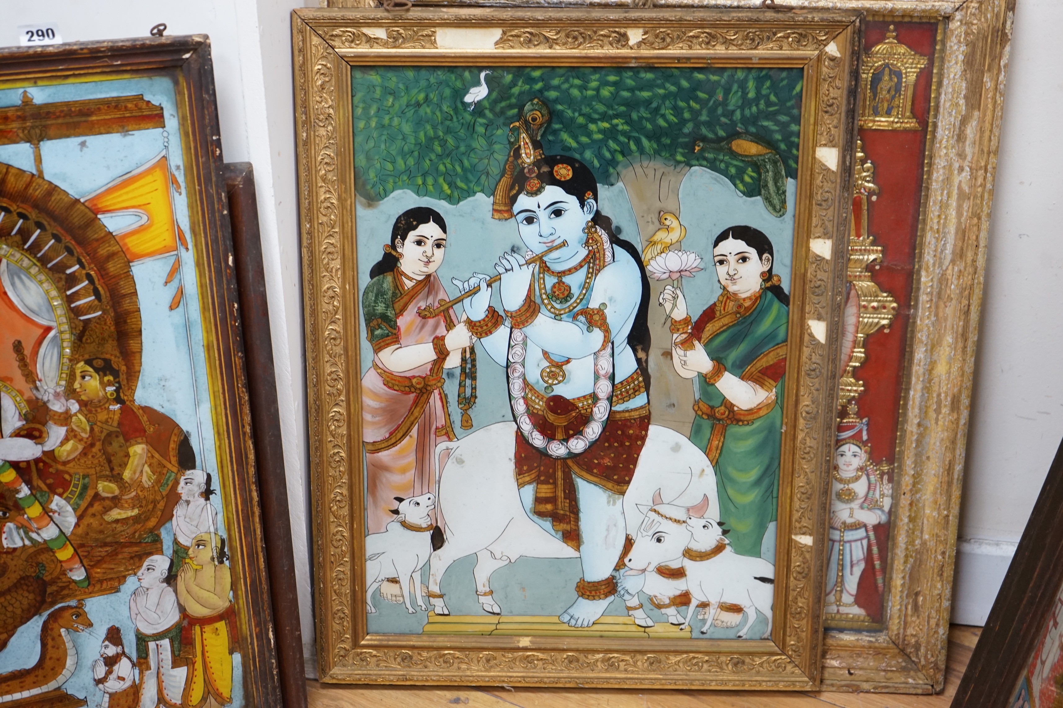 A collection of eight Indian reverse decorated glass pictures, 20th century, largest frame 70cm X 60cm